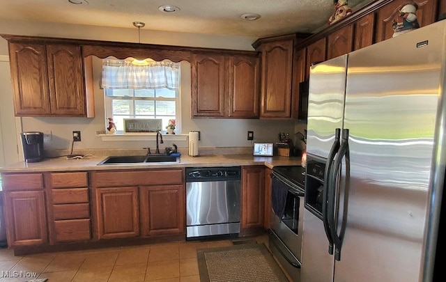 kitchen with a notable chandelier, light tile patterned flooring, sink, and stainless steel appliances