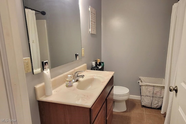 bathroom with toilet, vanity, tile patterned floors, and a shower with shower curtain