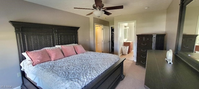 bedroom with ensuite bath, ceiling fan, and light carpet