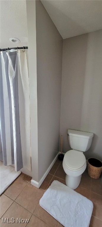 bathroom with tile patterned flooring and toilet