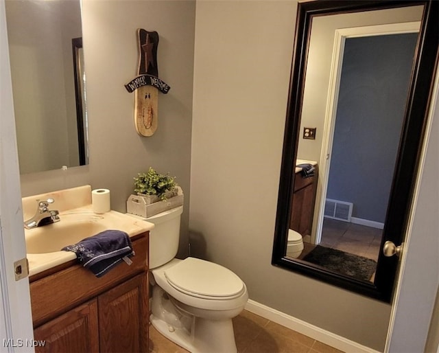 bathroom with tile patterned flooring, vanity, and toilet