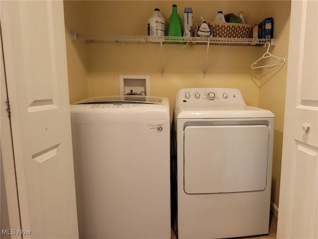 clothes washing area with separate washer and dryer