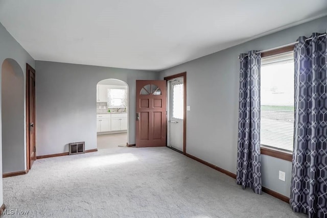 entrance foyer with light colored carpet