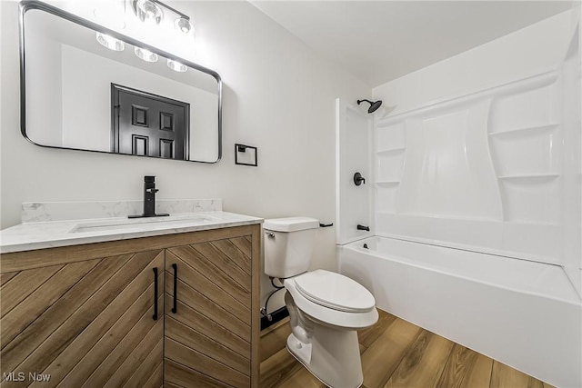 full bathroom featuring shower / tub combination, toilet, vanity, and hardwood / wood-style flooring