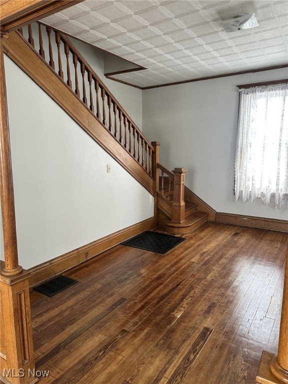 stairway featuring hardwood / wood-style flooring