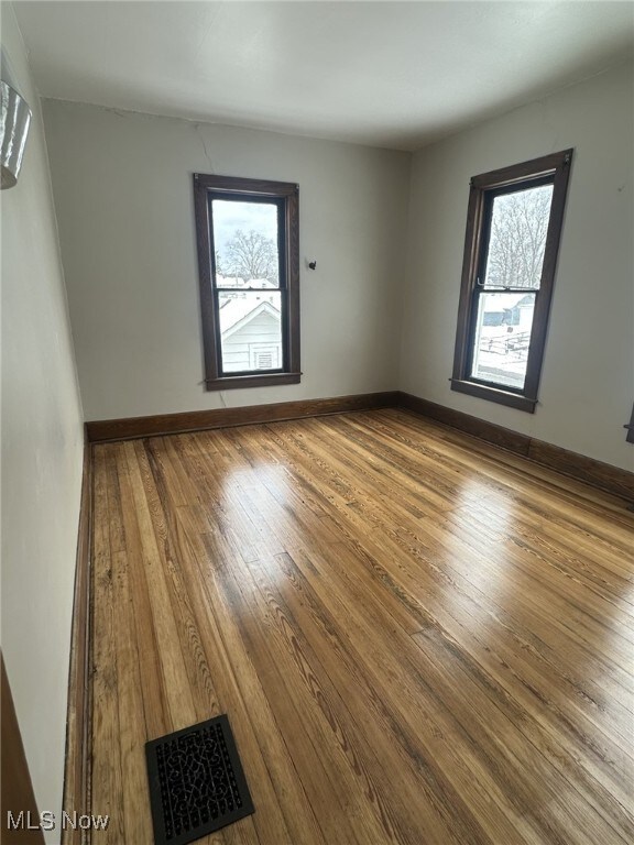 spare room featuring hardwood / wood-style flooring