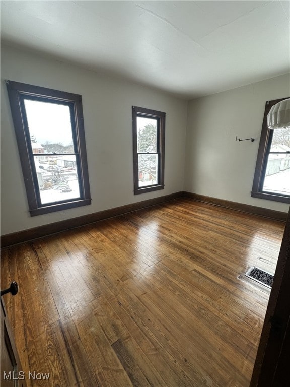 unfurnished room featuring dark wood-type flooring