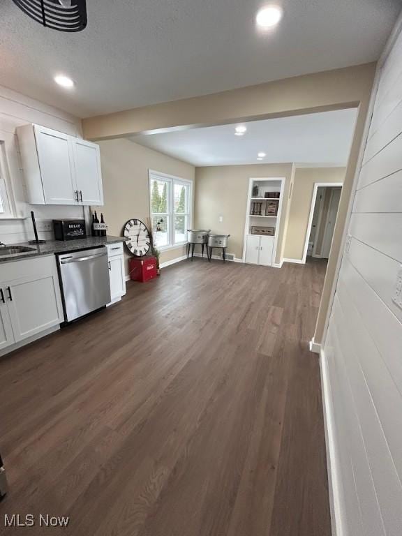 kitchen featuring stainless steel dishwasher, a textured ceiling, sink, white cabinets, and dark hardwood / wood-style floors