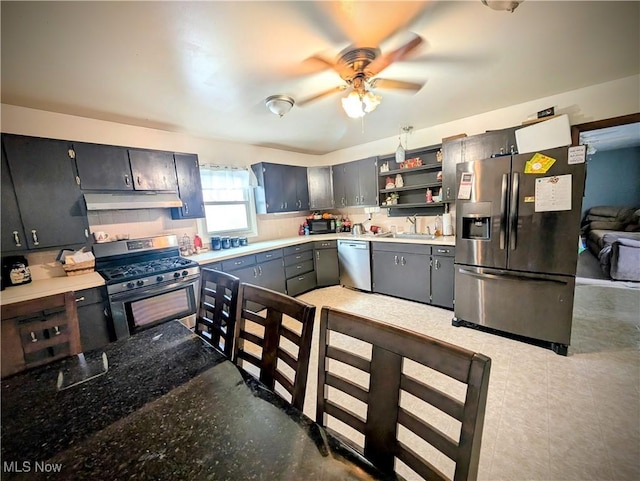 kitchen with appliances with stainless steel finishes, ceiling fan, and sink