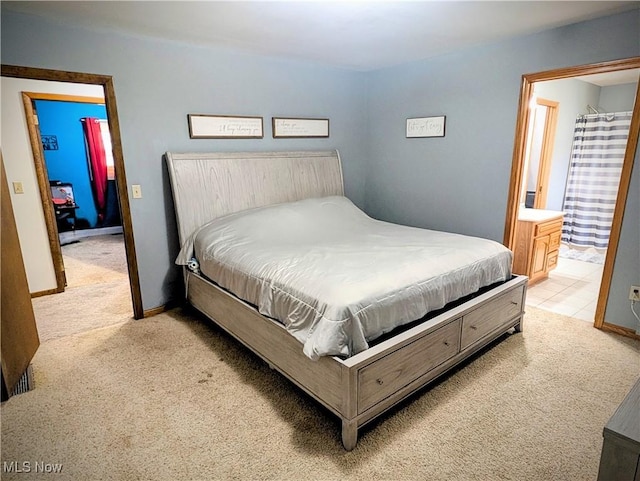 carpeted bedroom with ensuite bathroom