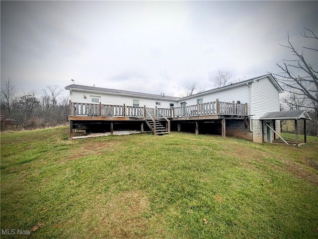 rear view of property with a lawn and a wooden deck