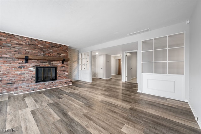 unfurnished living room with a fireplace and hardwood / wood-style flooring