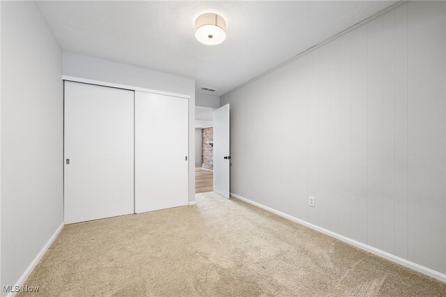 unfurnished bedroom featuring carpet floors and a closet