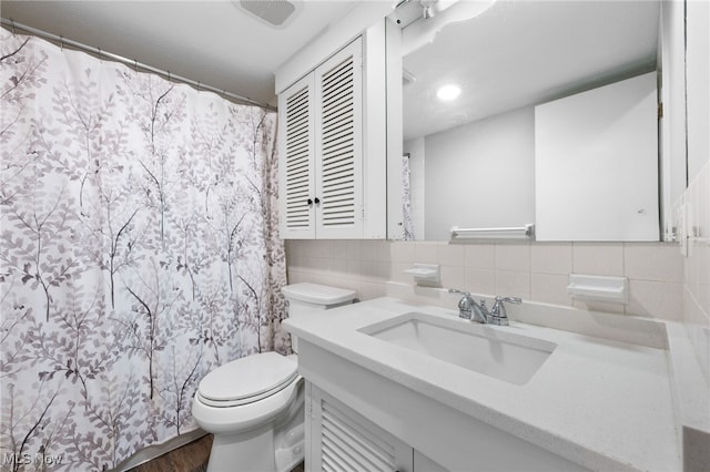 bathroom featuring hardwood / wood-style flooring, vanity, toilet, and decorative backsplash