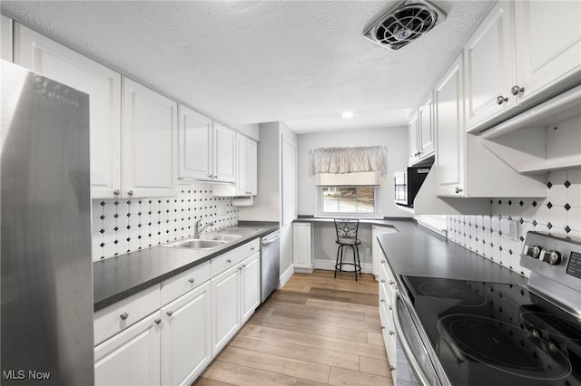 kitchen featuring white cabinets, appliances with stainless steel finishes, and sink