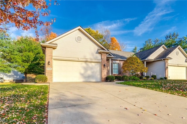 ranch-style home featuring a garage and a front lawn