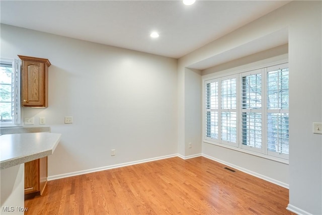 unfurnished dining area featuring plenty of natural light and light hardwood / wood-style floors