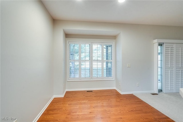 unfurnished room with light hardwood / wood-style floors