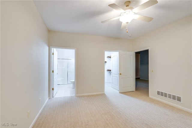 spare room featuring light colored carpet and ceiling fan