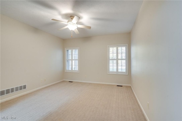 empty room with light carpet and ceiling fan