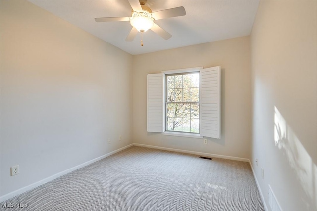 unfurnished room featuring ceiling fan and light carpet