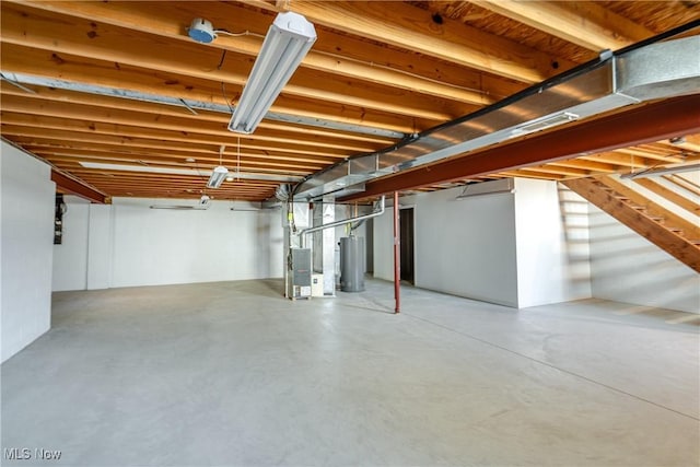 basement featuring heating unit and water heater