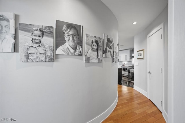 hall with hardwood / wood-style flooring