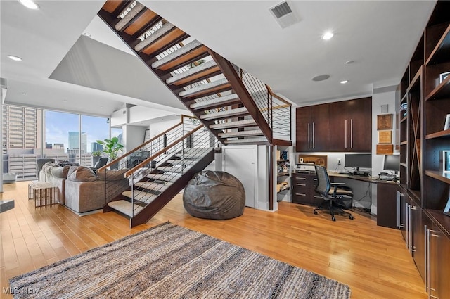 interior space with hardwood / wood-style floors and built in desk