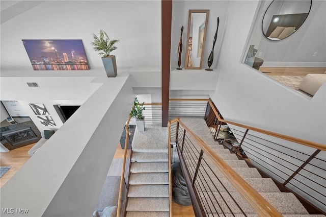 staircase with hardwood / wood-style flooring