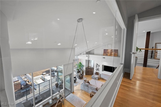 living room with light wood-type flooring and vaulted ceiling