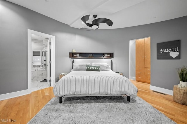 bedroom featuring ensuite bathroom, ceiling fan, and wood-type flooring