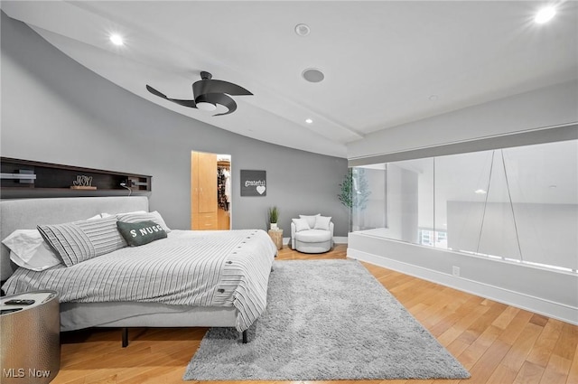 bedroom featuring hardwood / wood-style flooring, ceiling fan, and vaulted ceiling