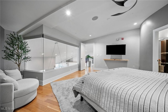 bedroom with light wood-type flooring and vaulted ceiling