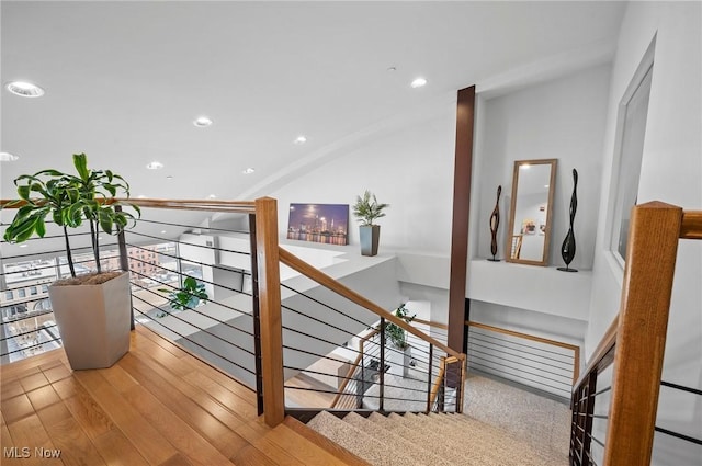 staircase with hardwood / wood-style floors