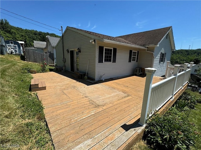 back of property featuring a wooden deck