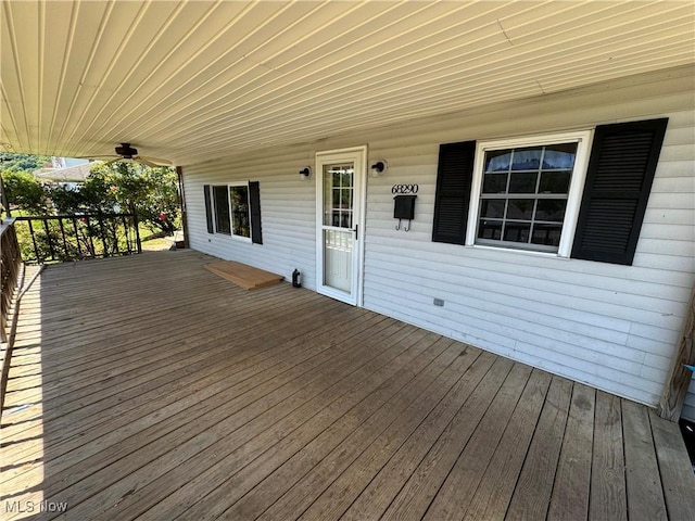 wooden deck featuring ceiling fan