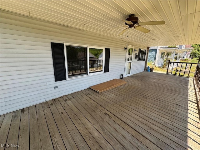 wooden terrace featuring ceiling fan