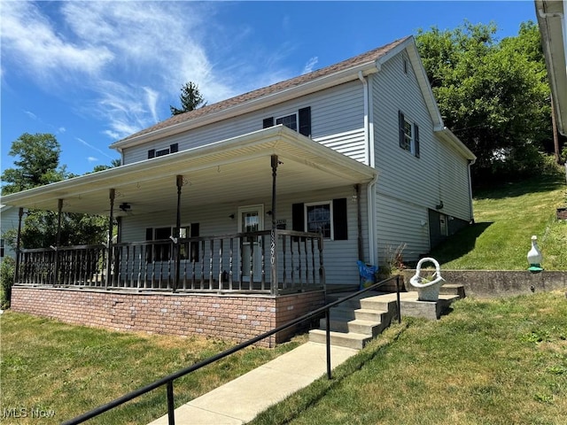 view of front of home with a porch and a front lawn