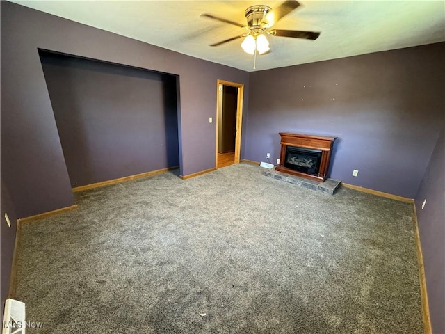 unfurnished living room featuring carpet and ceiling fan