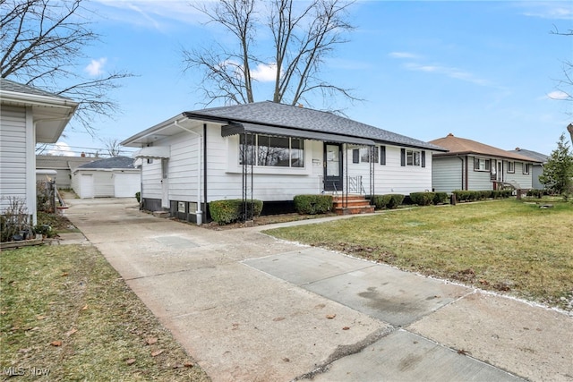 view of front facade featuring an outbuilding, a front yard, and a garage