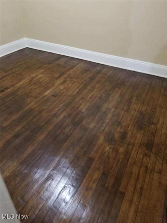 empty room featuring dark wood-type flooring