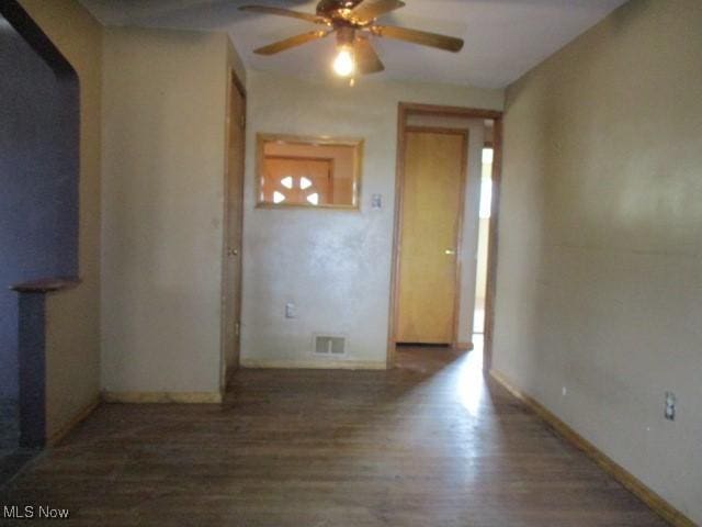 spare room with ceiling fan and dark hardwood / wood-style floors