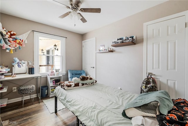 bedroom with hardwood / wood-style flooring and ceiling fan