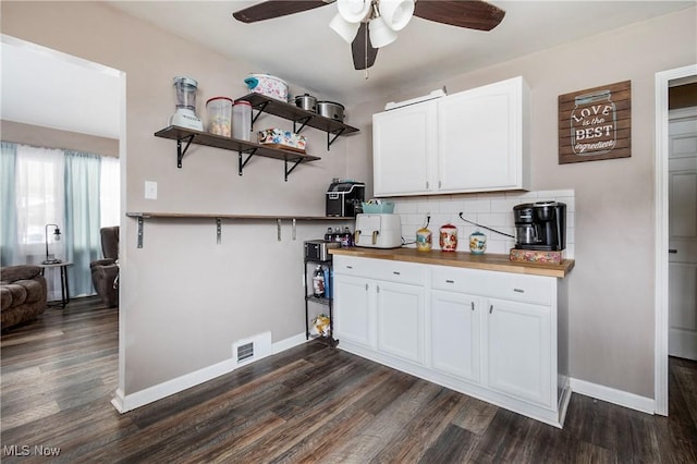 kitchen featuring butcher block counters, ceiling fan, tasteful backsplash, dark hardwood / wood-style flooring, and white cabinetry