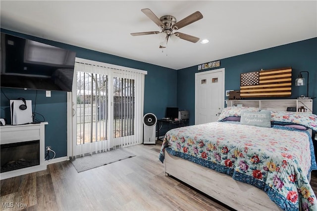 bedroom with hardwood / wood-style flooring and ceiling fan