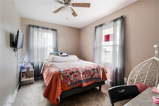 bedroom with carpet, multiple windows, and ceiling fan