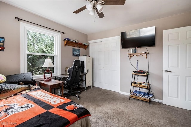 carpeted bedroom featuring ceiling fan and a closet