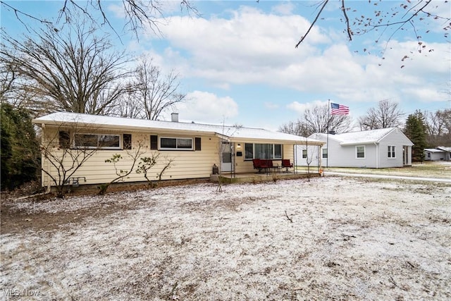 view of snow covered rear of property