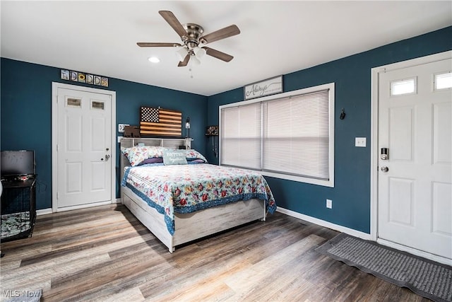 bedroom with wood-type flooring and ceiling fan