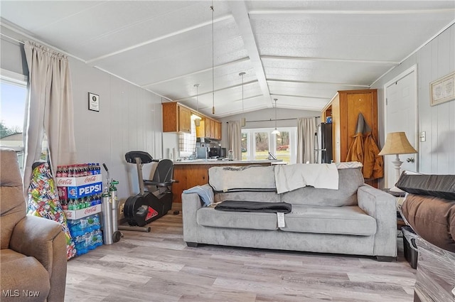 living room featuring wood walls, light hardwood / wood-style flooring, and vaulted ceiling with beams